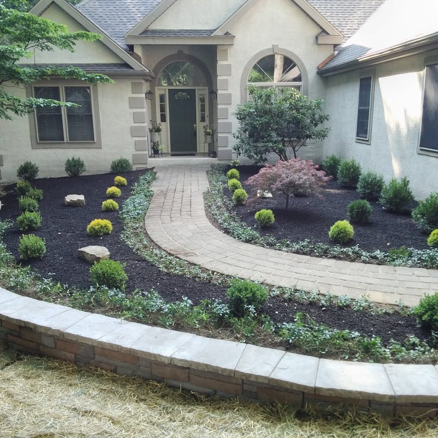 hardscaped wallway with landscaping leading to front door