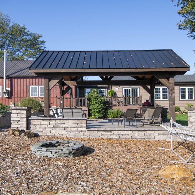 Rearview shot of pavilion with fire pit and hammock