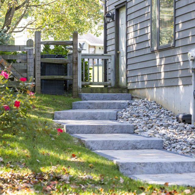 ground level shot of hardscaped stairs leading down to hill