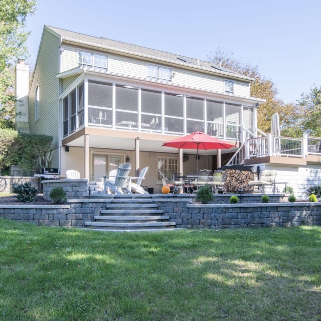 ground level shot of outdoor entertainment space from backyard looking in