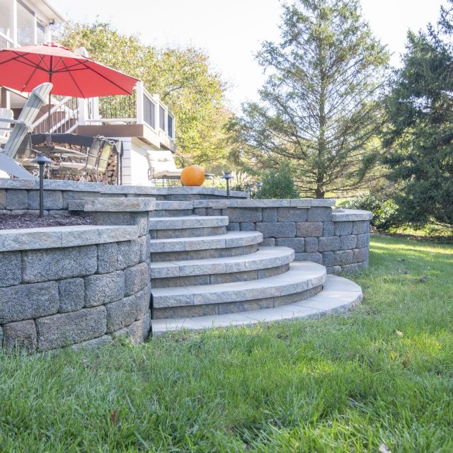 hardscaped steps off of patio into the grass