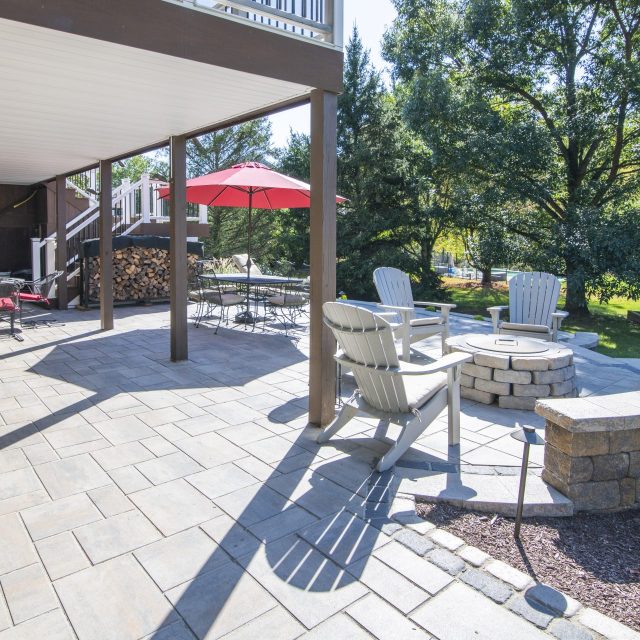 side view of the underneath of deck with hardscaped patio and enterainment area