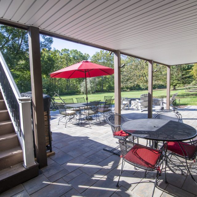 photo from underneath deck of outdoor dining tables