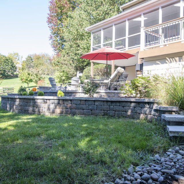 right side photo of hardscaped patio and wall