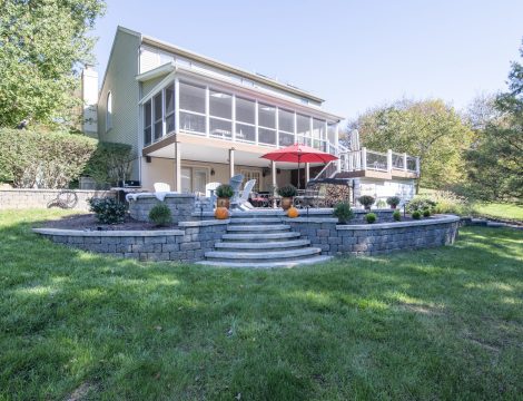 ground level shot of backyard patio, deck, and porch