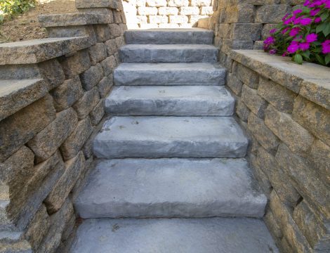 Outdoor paver installed stairs with purple flowers in bloom