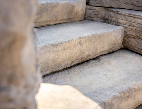 Close up of natural stone landscape steps with textured edges and layered wall